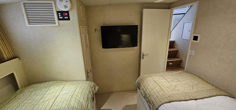 Slide: The Image of Cozy cabin interior of 1969 Derecktor 68 Hunt Motor Yacht with twin beds and elegant decor. - 17