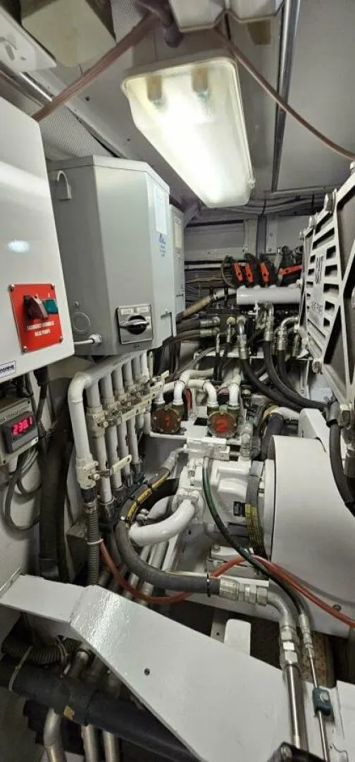 Slide: The Image of Engine room of 1969 Derecktor 68 Hunt Motor Yacht, showcasing complex piping and machinery. - 23