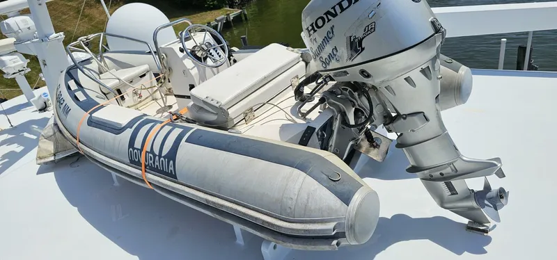 Slide: The Image of 1969 Derecktor 68 Hunt Motor Yacht with Novurania inflatable boat and Honda outboard motor. - 28