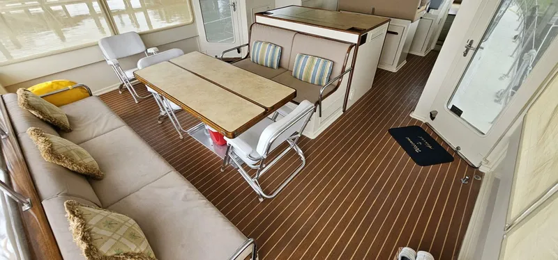 Slide: The Image of 1969 Derecktor 68 Hunt Motor Yacht deck with seating and wooden accents. - 5