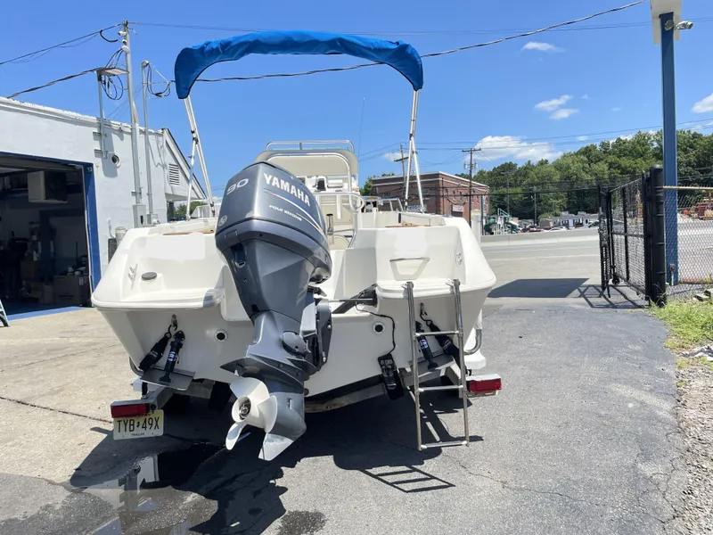 Slide: The Image of 1999 Campion Explorer 582 boat with Yamaha outboard motor and blue canopy. - 2