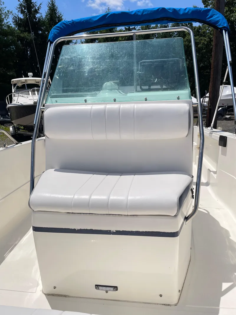 Slide: The Image of 1999 Campion Explorer 582 boat with white seating and blue canopy. - 5