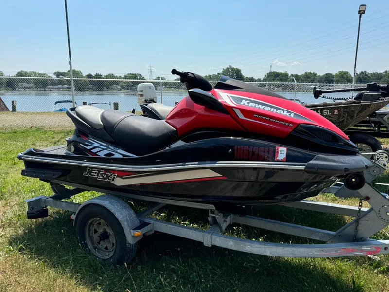 Slide: The Image of 2019 Kawasaki Jetski Ultra 310X on trailer by a lakeside. - 1
