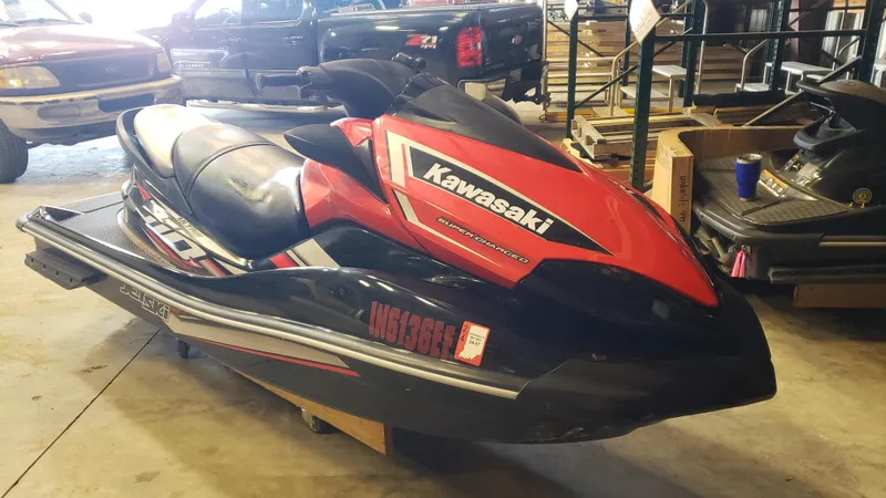 Slide: The Image of 2019 Kawasaki Jetski Ultra 310X in a garage setting, red and black design. - 2