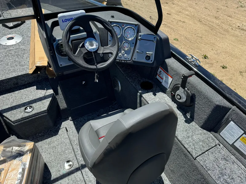 Slide: The Image of 2024 Tracker Pro Guide V-175 Combo boat interior with steering wheel and control panel. - 10