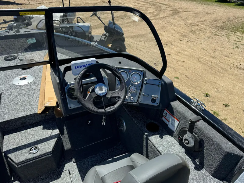 Slide: The Image of 2024 Tracker Pro Guide V-175 Combo boat dashboard with steering wheel and control panel. - 11