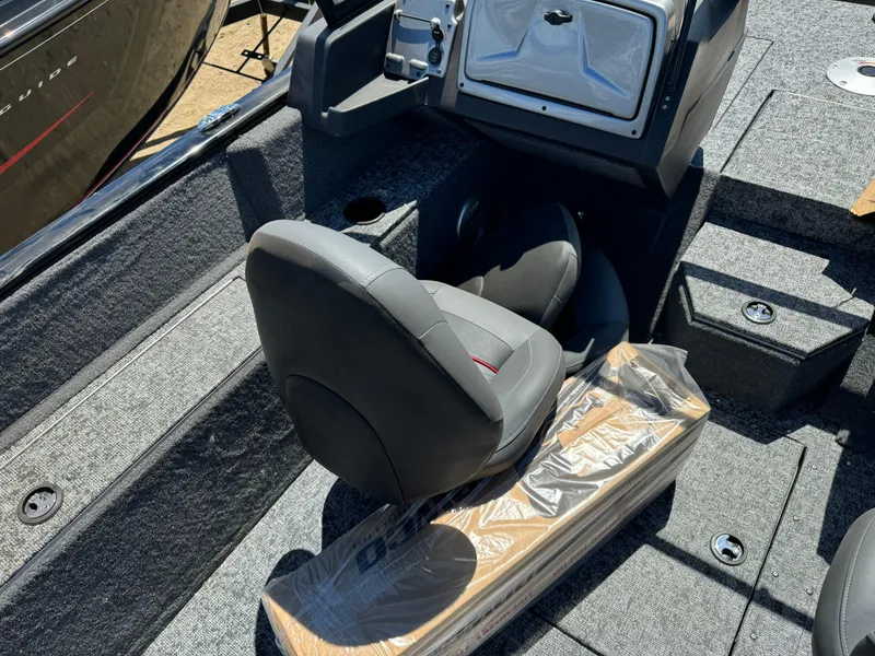 Slide: The Image of 2024 Tracker Pro Guide V-175 Combo boat interior with captain's seat and console. - 12