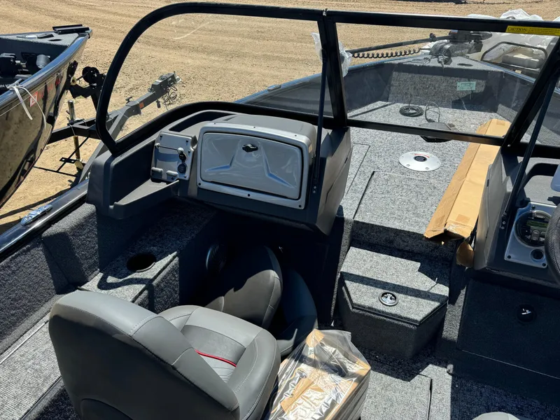 Slide: The Image of 2024 Tracker Pro Guide V-175 Combo boat interior with seating and dashboard. - 14