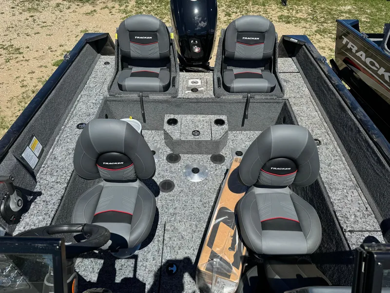 Slide: The Image of 2024 Tracker Pro Guide V-175 Combo boat interior with four gray seats. - 16
