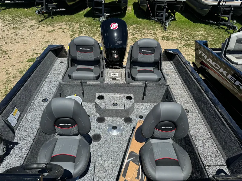 Slide: The Image of 2024 Tracker Pro Guide V-175 Combo fishing boat interior with four seats and motor. - 17