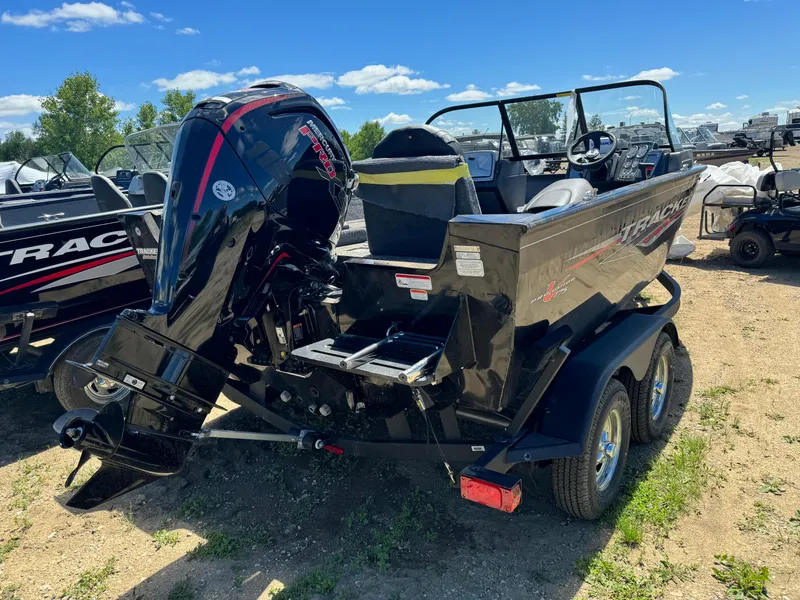 Slide: The Image of 2024 Tracker Pro Guide V-175 Combo boat on a trailer, rear view with outboard motor. - 3