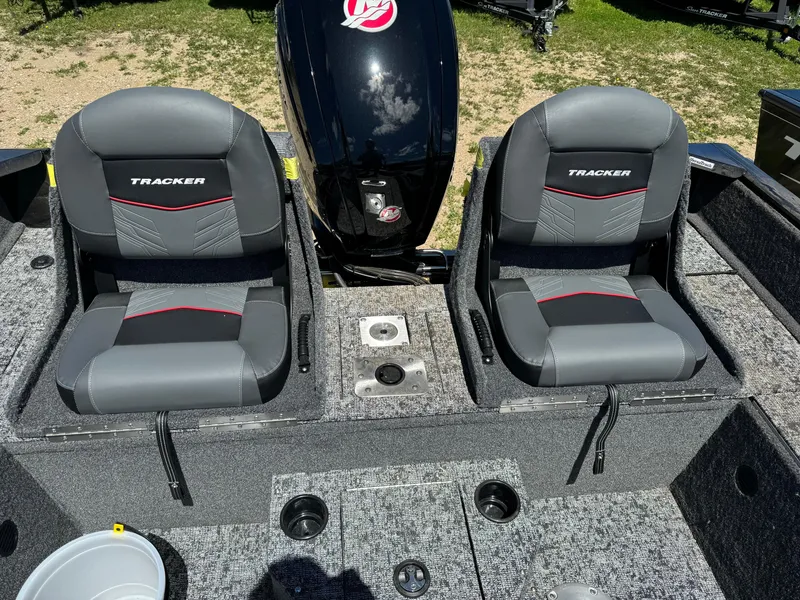 Slide: The Image of 2024 Tracker Pro Guide V-175 Combo boat interior with two seats and motor. - 6