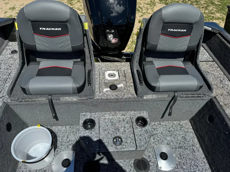 Slide: The Image of 2024 Tracker Pro Guide V-175 Combo boat interior with two seats and storage compartments. - 7