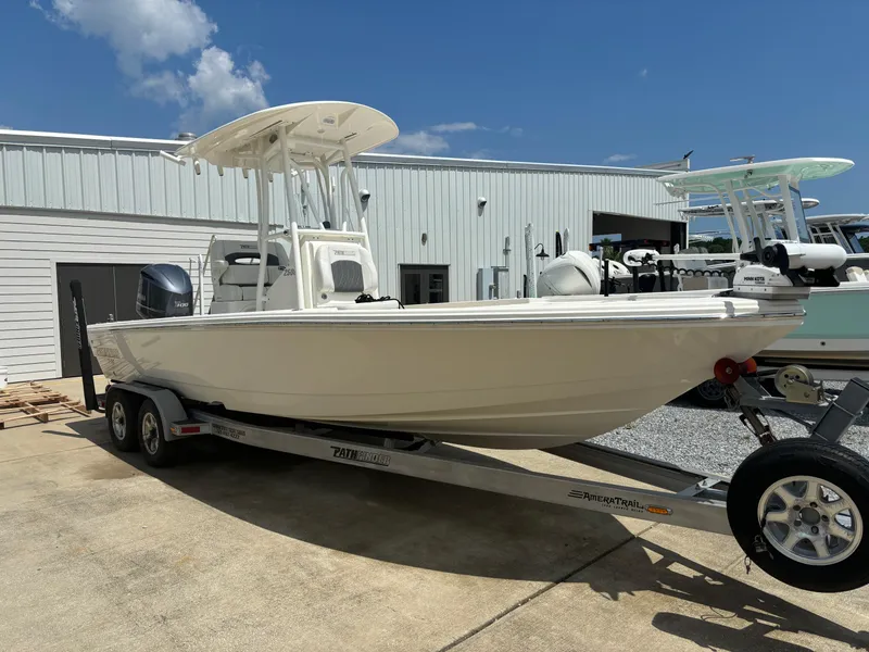 The Image of 2021 Pathfinder 2500 Hybrid boat on a trailer in a marina. - 1