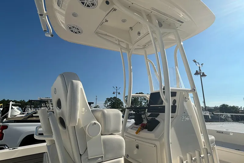 Slide: The Image of 2021 Pathfinder 2500 Hybrid boat interior with white seating and control console. - 15