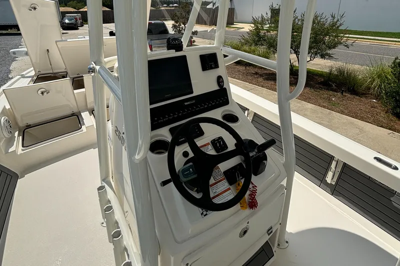 Slide: The Image of 2021 Pathfinder 2500 Hybrid boat console with steering wheel and navigation system. - 18