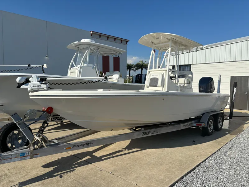 Slide: The Image of 2021 Pathfinder 2500 Hybrid boat on a trailer outside a warehouse. - 2