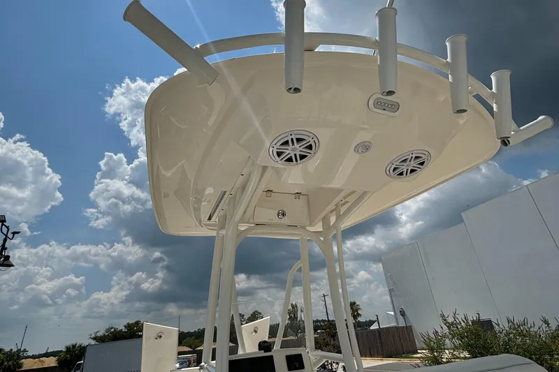 Slide: The Image of 2021 Pathfinder 2500 Hybrid boat with T-top and rod holders under a cloudy sky. - 21