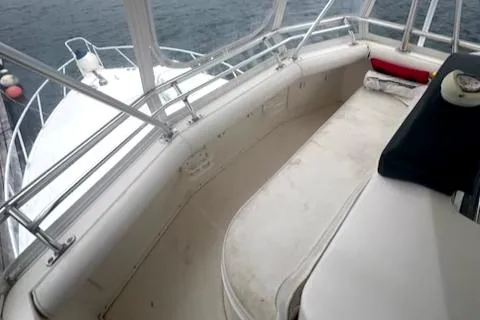 Slide: The Image of 2002 Cabo 35 Flybridge boat interior with cushioned seating and ocean view. - 12