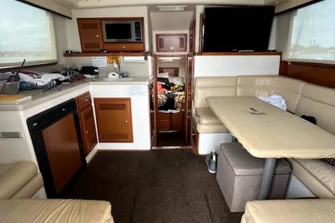 Slide: The Image of Interior of a 2002 Cabo 35 Flybridge boat with kitchen and dining area. - 16