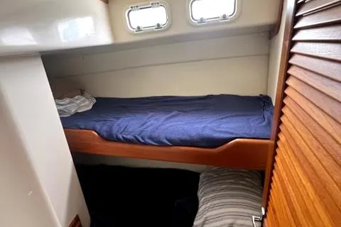 Slide: The Image of 2002 Cabo 35 Flybridge interior cabin with bunk beds and porthole windows. - 18