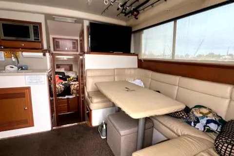 Slide: The Image of Interior of 2002 Cabo 35 Flybridge with dining area, kitchen, and sleeping quarters. - 20