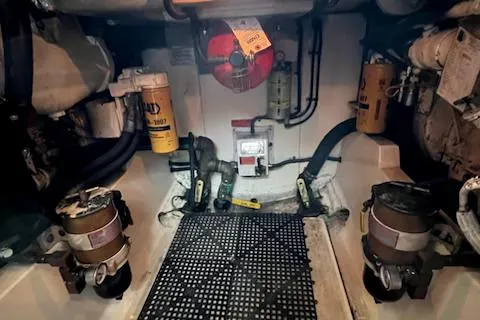 Slide: The Image of Engine room of a 2002 Cabo 35 Flybridge boat with various mechanical components. - 25