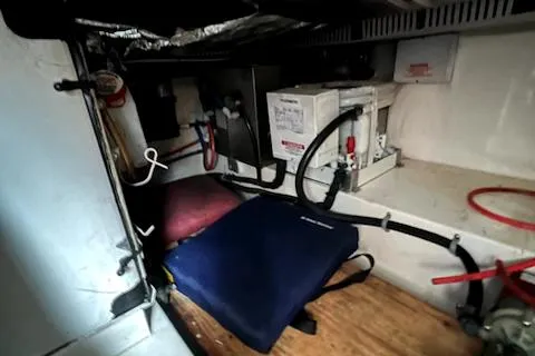 Slide: The Image of Engine compartment of a 2002 Cabo 35 Flybridge boat with various equipment and wiring. - 26