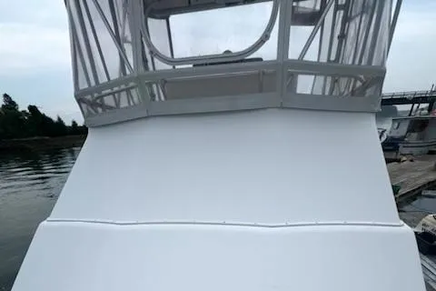 Slide: The Image of 2002 Cabo 35 Flybridge boat with enclosed flybridge at dock. - 32