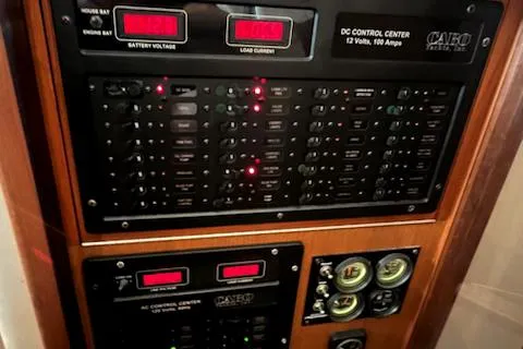 Slide: The Image of Control panel of a 2002 Cabo 35 Flybridge boat with various gauges and switches. - 34