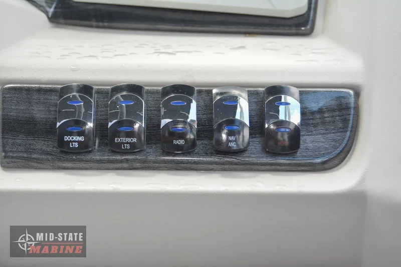 Slide: The Image of Control panel of 2024 Tahoe Pontoon LTZ Quad Lounger with labeled switches. - 12