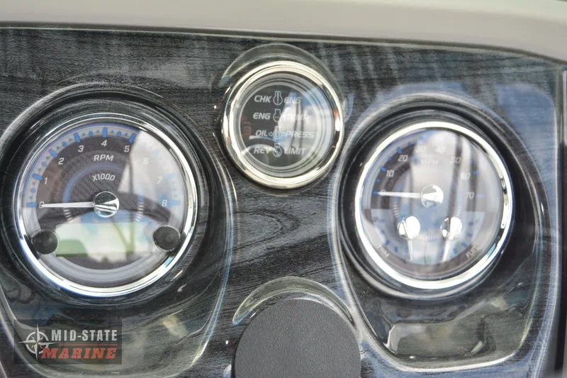 Slide: The Image of 2024 Tahoe Pontoon LTZ Quad Lounger dashboard with RPM and speed gauges. - 14