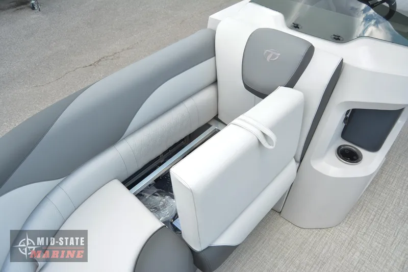 Slide: The Image of 2024 Tahoe Pontoon LTZ Quad Lounger interior seating with storage compartment. - 24