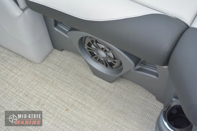 Slide: The Image of 2024 Tahoe Pontoon LTZ Quad Lounger interior with speaker and cup holder. - 26