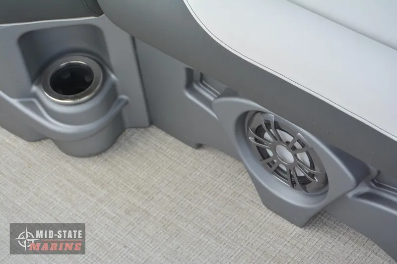 Slide: The Image of 2024 Tahoe Pontoon LTZ Quad Lounger interior with speaker and cup holder. - 29