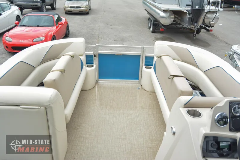 Slide: The Image of 2024 Tahoe Pontoon Sport 85 Quad Lounger interior with beige seating and blue accents. - 14