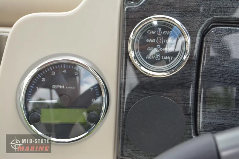Slide: The Image of 2024 Tahoe Pontoon Sport 85 Quad Lounger dashboard with RPM gauge and engine indicators. - 25