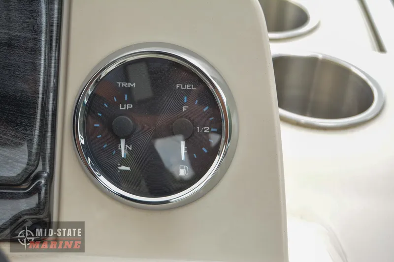 Slide: The Image of Close-up of 2024 Tahoe Pontoon Sport 85 Quad Lounger fuel and trim gauge. - 26