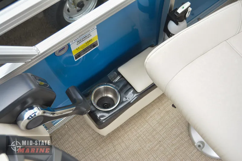 Slide: The Image of 2024 Tahoe Pontoon Sport 85 Quad Lounger interior with cup holder and control lever. - 30