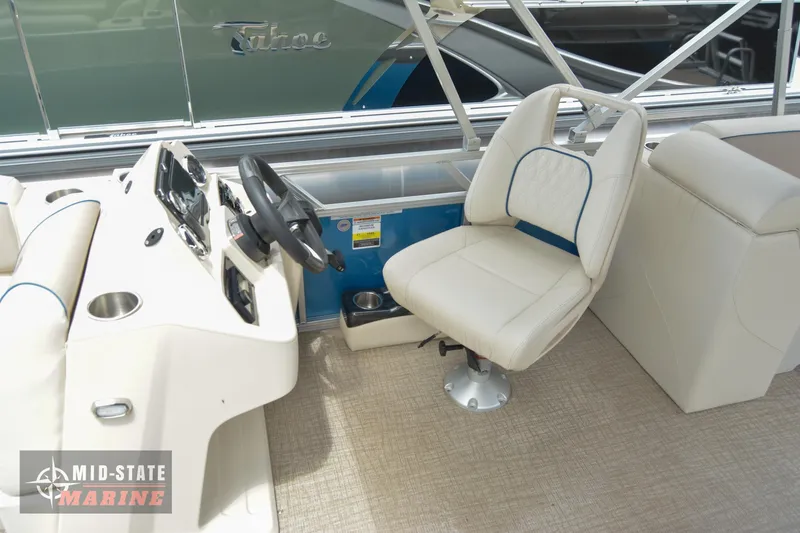 Slide: The Image of 2024 Tahoe Pontoon Sport 85 Quad Lounger interior with captain's chair and control console. - 9