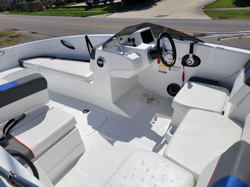 Slide: The Image of 2024 Tahoe T16 boat interior with white seating and steering console. - 13