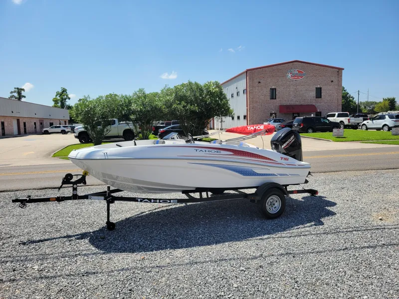 Slide: The Image of 2024 Tahoe T16 boat on a trailer in a parking lot. - 2