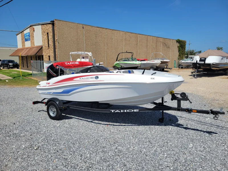 Slide: The Image of 2024 Tahoe T16 boat on a trailer in a dealership lot. - 7