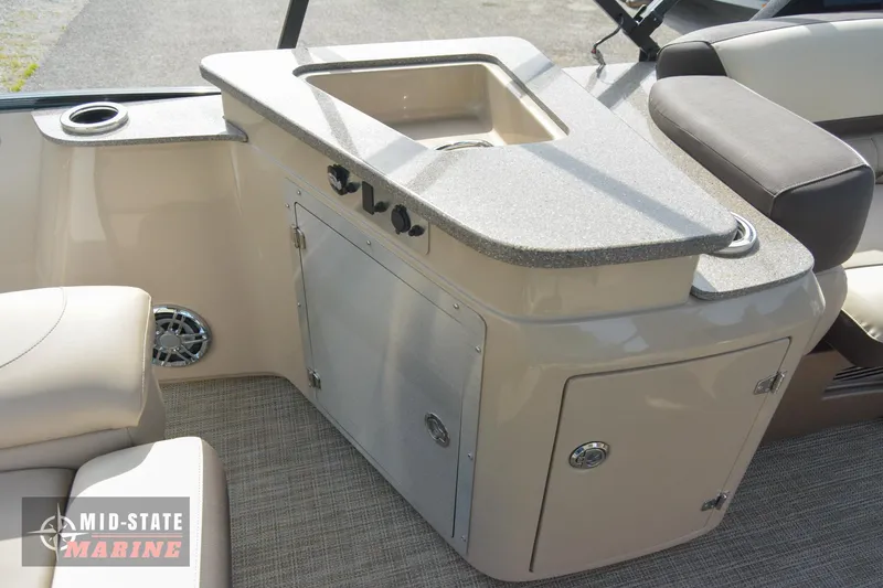 Slide: The Image of 2024 Tahoe Pontoon Cascade Elite Windshield interior with sink and storage. - 16