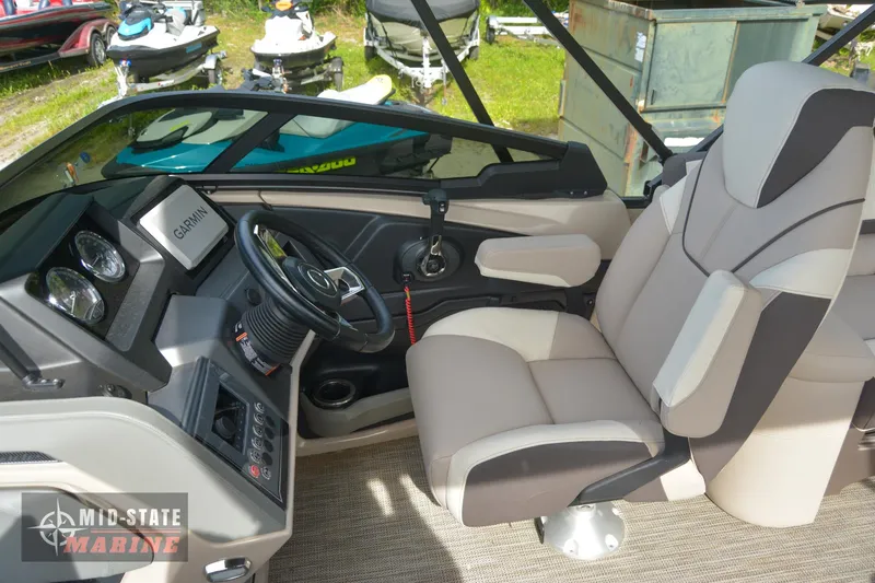 Slide: The Image of 2024 Tahoe Pontoon Cascade Elite Windshield boat cockpit with captain's chair and control panel. - 19