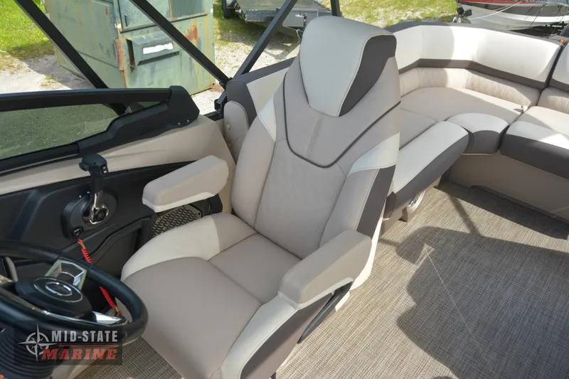 Slide: The Image of 2024 Tahoe Pontoon Cascade Elite Windshield interior with captain's chair and seating area. - 20