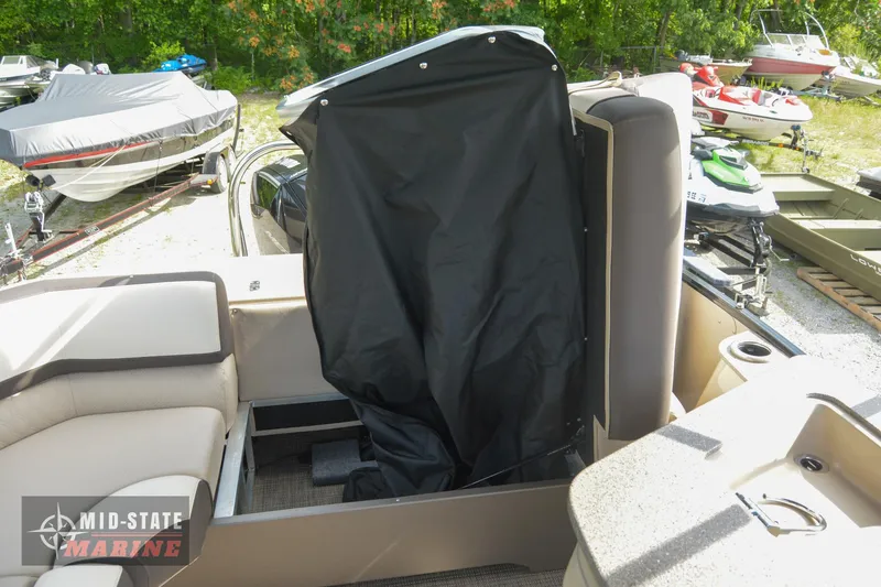 Slide: The Image of 2024 Tahoe Pontoon Cascade Elite Windshield interior with covered seating area. - 26