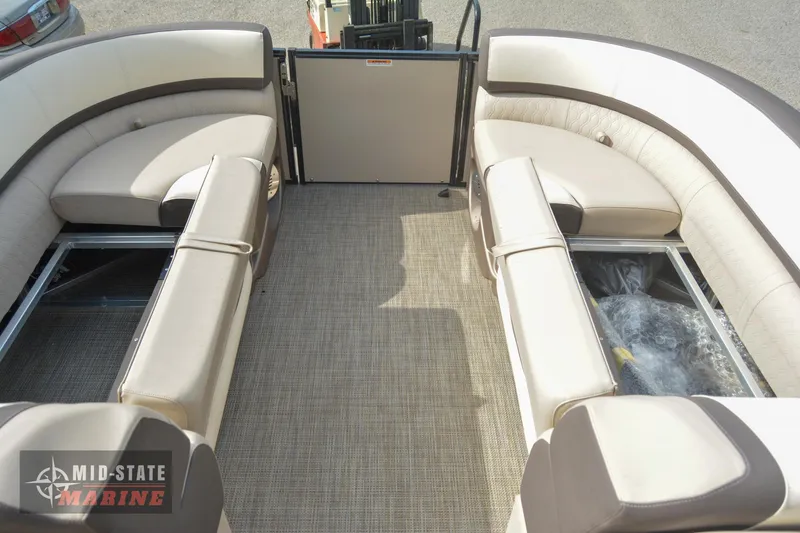 Slide: The Image of 2024 Tahoe Pontoon Cascade Elite Windshield interior with beige seating and storage compartments. - 29