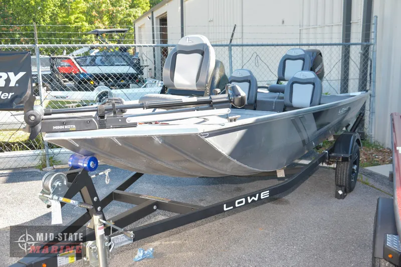 Slide: The Image of 2024 Lowe Skorpion 16 fishing boat on a trailer in a dealership lot. - 0