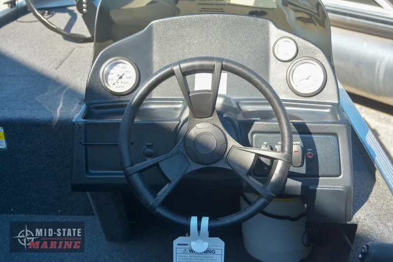 Slide: The Image of 2024 Lowe Skorpion 16 boat dashboard with steering wheel and gauges. - 14